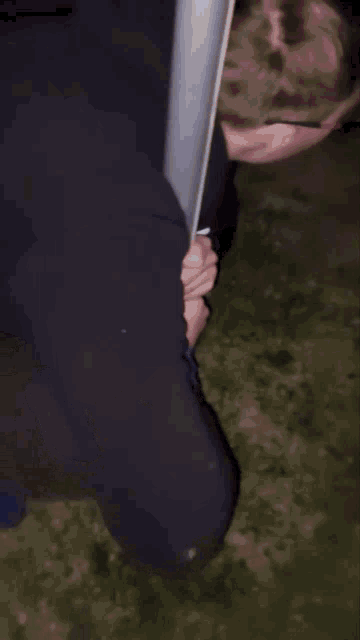 a man wearing glasses is holding a pole with his head in it