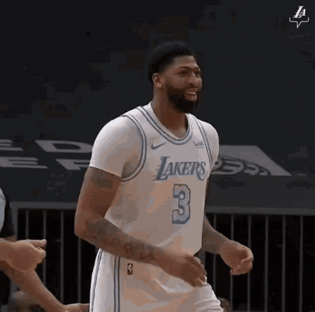 anthony davis is a basketball player for the los angeles lakers and is celebrating on the court .