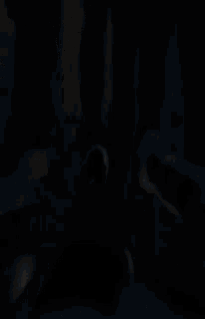 a group of people standing next to each other with their shadows visible