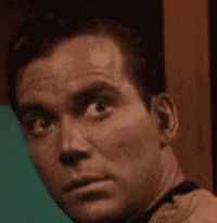 a close up of a man 's face with a yellow shirt on making a funny face .
