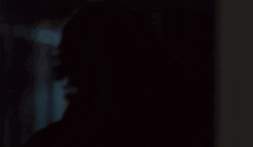 a blurry picture of a person 's face in a dark room