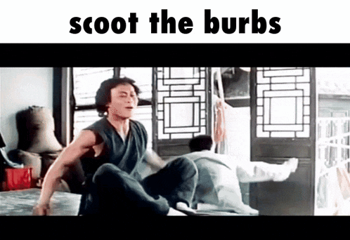 a man is sitting on a bed in a room with the words scoot the burbs written above him .