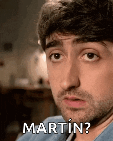 a man with a beard is making a funny face and the word martin is on his face .