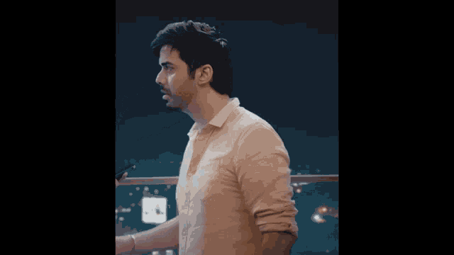 a man in a white shirt is looking at something