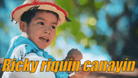a young boy wearing a straw hat and a blue shirt says ricky riquin canayin