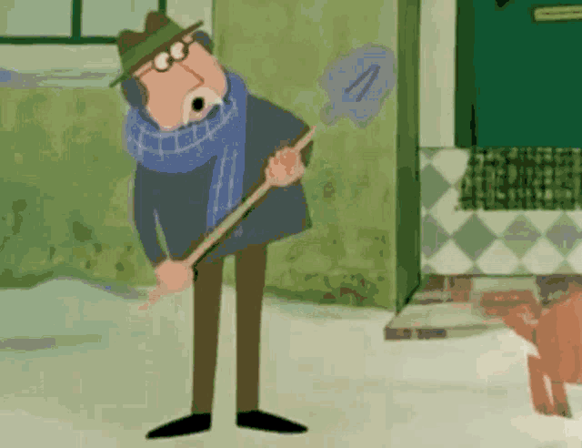 a man wearing a hat and scarf is holding a shovel
