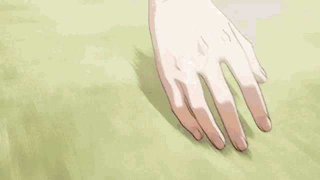a person is kneeling down on the floor with their hands on their hips .