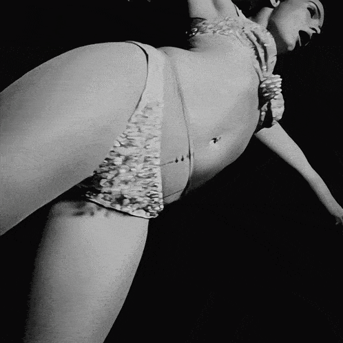 a black and white photo of a woman in a white bikini