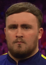 a man with a beard and a blue shirt is looking at the camera