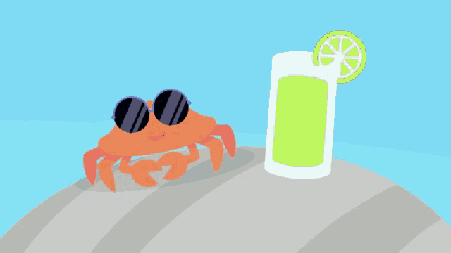 a crab wearing sunglasses next to a glass of green liquid