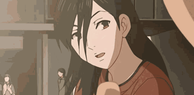 a girl with long black hair is looking at the camera