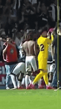 a soccer player in a yellow jersey with the number 2 on it