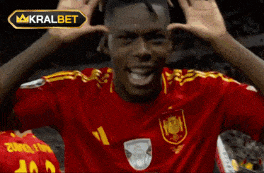 a soccer player in a red shirt with the number 1 on it