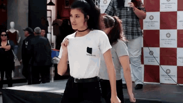a woman wearing a shirt that says anarchy is standing on a stage