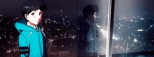 a boy in a blue jacket is standing in front of a window with a city in the background