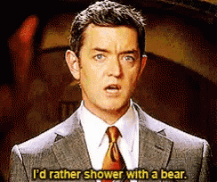 a man in a suit and tie is saying that he would rather shower with a bear
