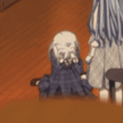a girl in a blue dress is kneeling down on the floor while a woman stands behind her .