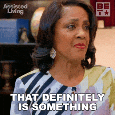 a woman says that definitely is something in front of an assisted living poster
