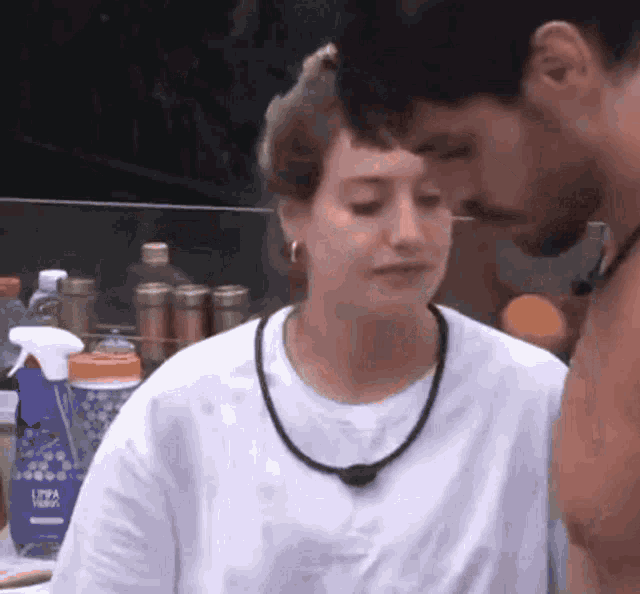 a man and a woman are standing next to each other and the woman is wearing a nivea lotion