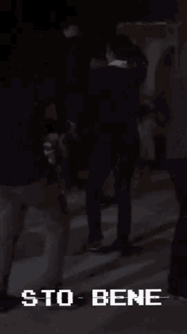 a man is dancing in front of a crowd and the words sto bene are on the bottom