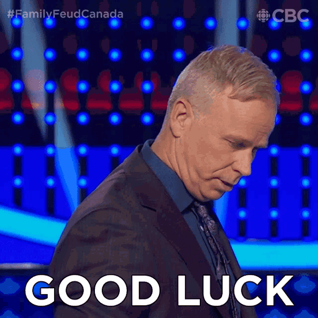a man in a suit says good luck in front of a cbs logo