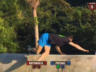 a man in blue shorts is jumping over a wall with a sign that says payraz on it .