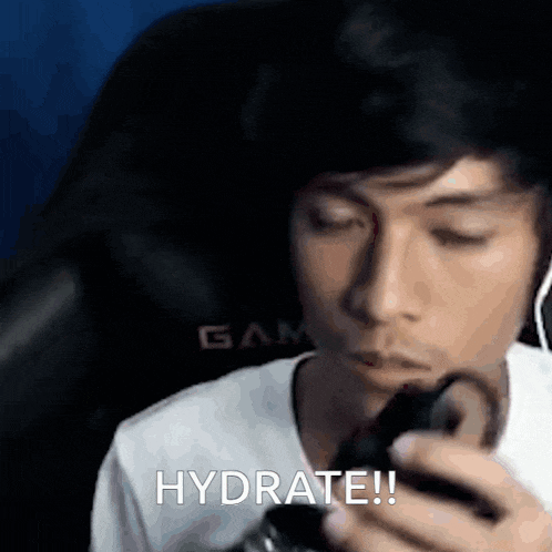 a man is holding a cell phone in his hand and saying hydrate !