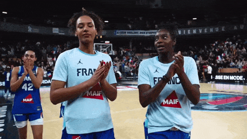 two female basketball players wearing blue jerseys that say maif
