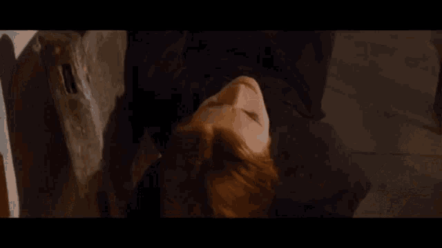 a woman with red hair is laying upside down