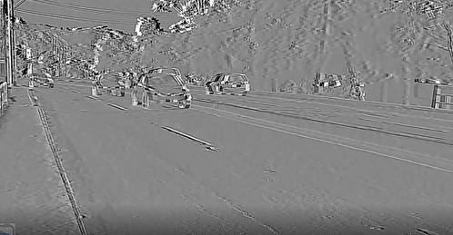 a black and white photo of cars driving down a road .