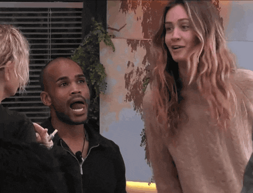 a man with a beard and a woman with long blonde hair are standing next to each other
