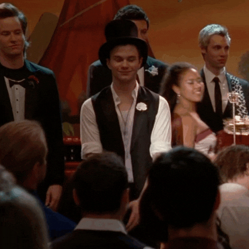 a man in a top hat stands in a crowd