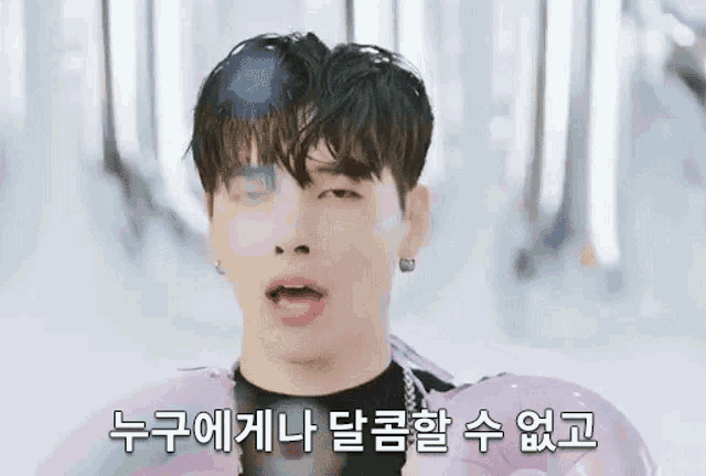 a young man is making a funny face while holding an inflatable ring .