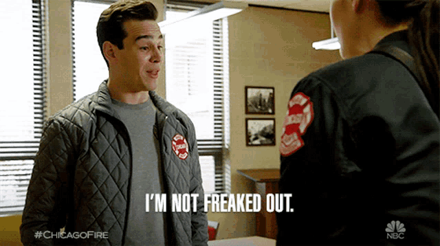 a man in a chicago fire uniform is talking to a woman