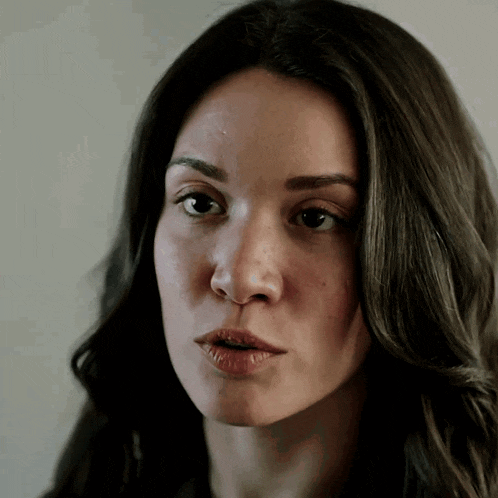 a close up of a woman 's face with long hair