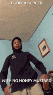 a man wearing a hoodie with the words eatin a burger with no honey mustard below him