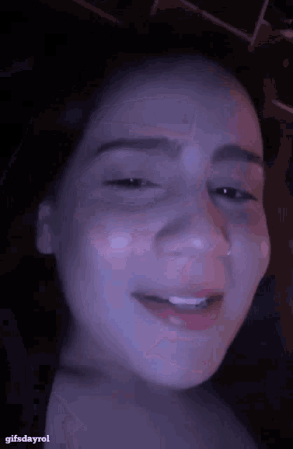 a close up of a woman 's face with the words gifsdayrol on the bottom