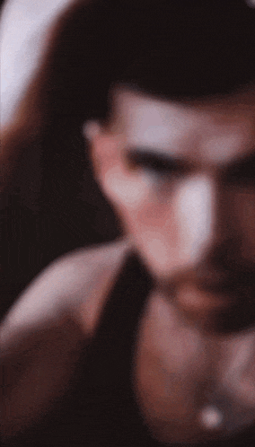 a blurry picture of a man 's face with a beard