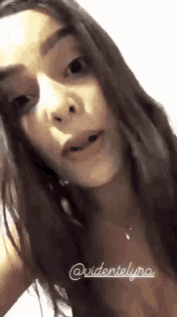 a close up of a woman 's face with her mouth open and a necklace on her neck .