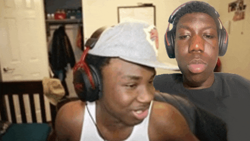 a man wearing headphones looks at the camera