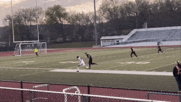 a soccer game is being played on a field with the letters s and t on it