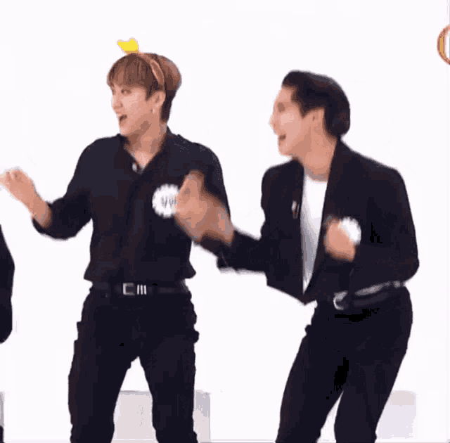 two men are dancing and one has a sticker on his shirt that says ' ii '