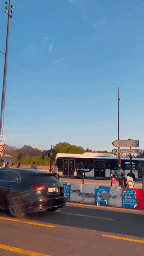 a black car is driving down a street in front of a sign that says 666