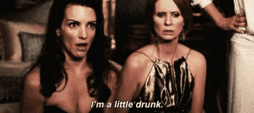 two women are sitting next to each other and one is saying `` i 'm a little drunk . ''