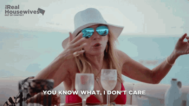 a woman wearing sunglasses and a hat says you know what i don t care