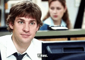 a man in a tie says " yikes " in front of a computer