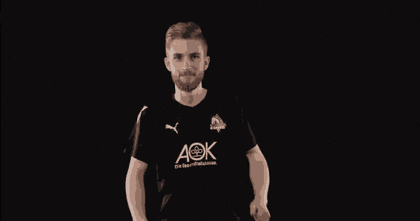 a man wearing a black shirt that says aok