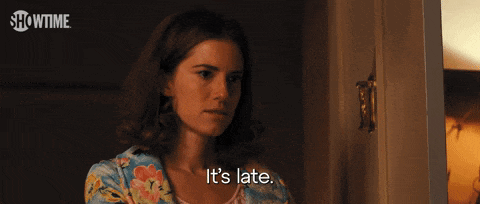 a woman is standing in a doorway and says you better go to bed .