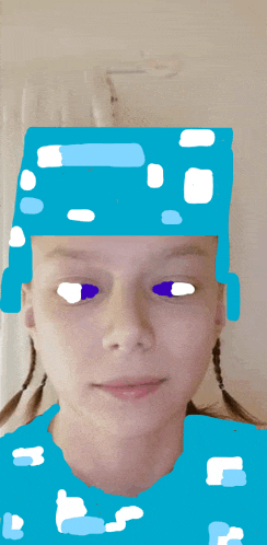 a girl wearing a blue hat with white dots on it