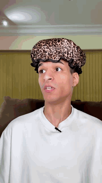 a man wearing a shower cap with a leopard print